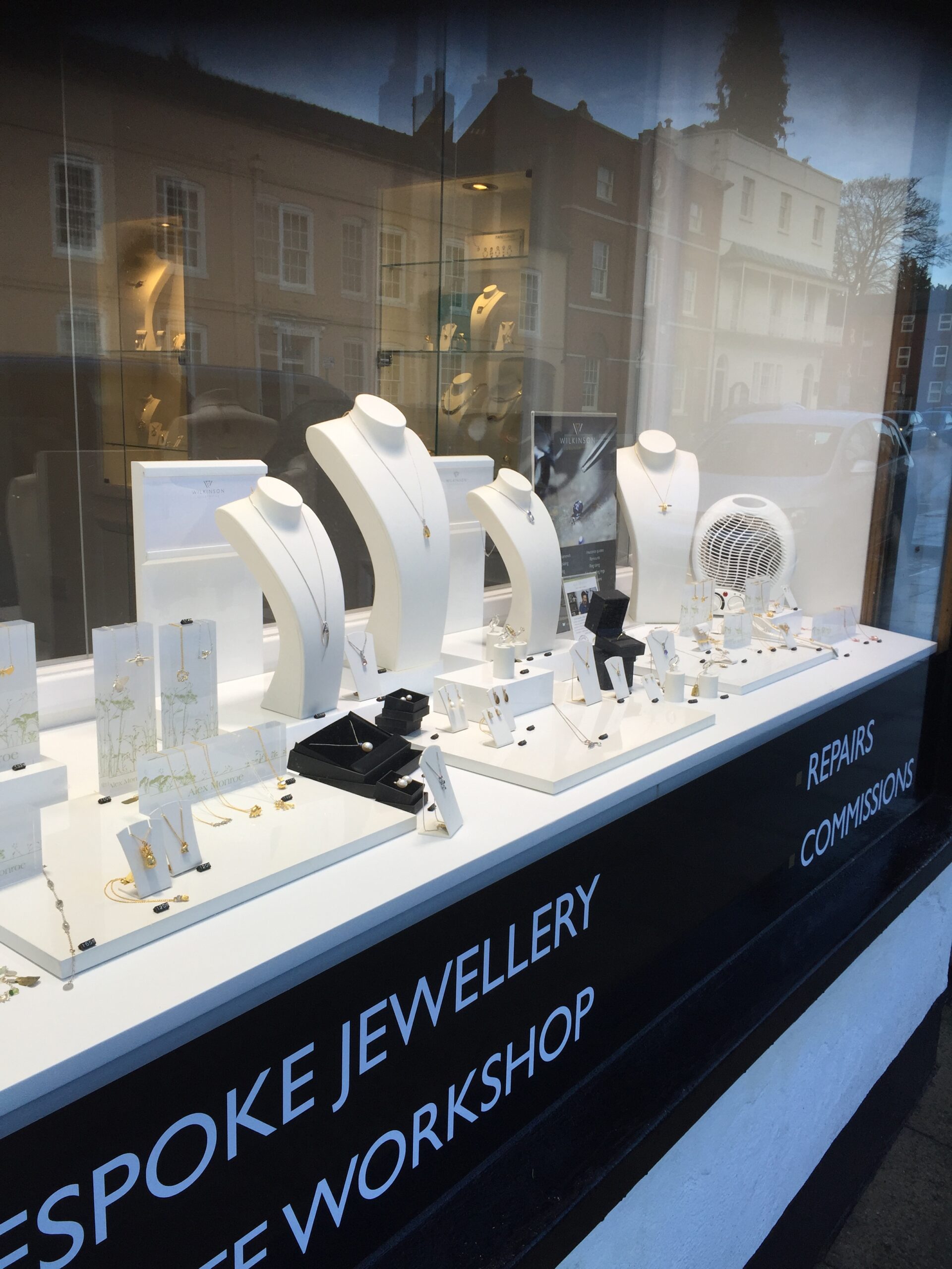 the Wilkinson Goldsmiths window with various pieces of jewellery on plinths